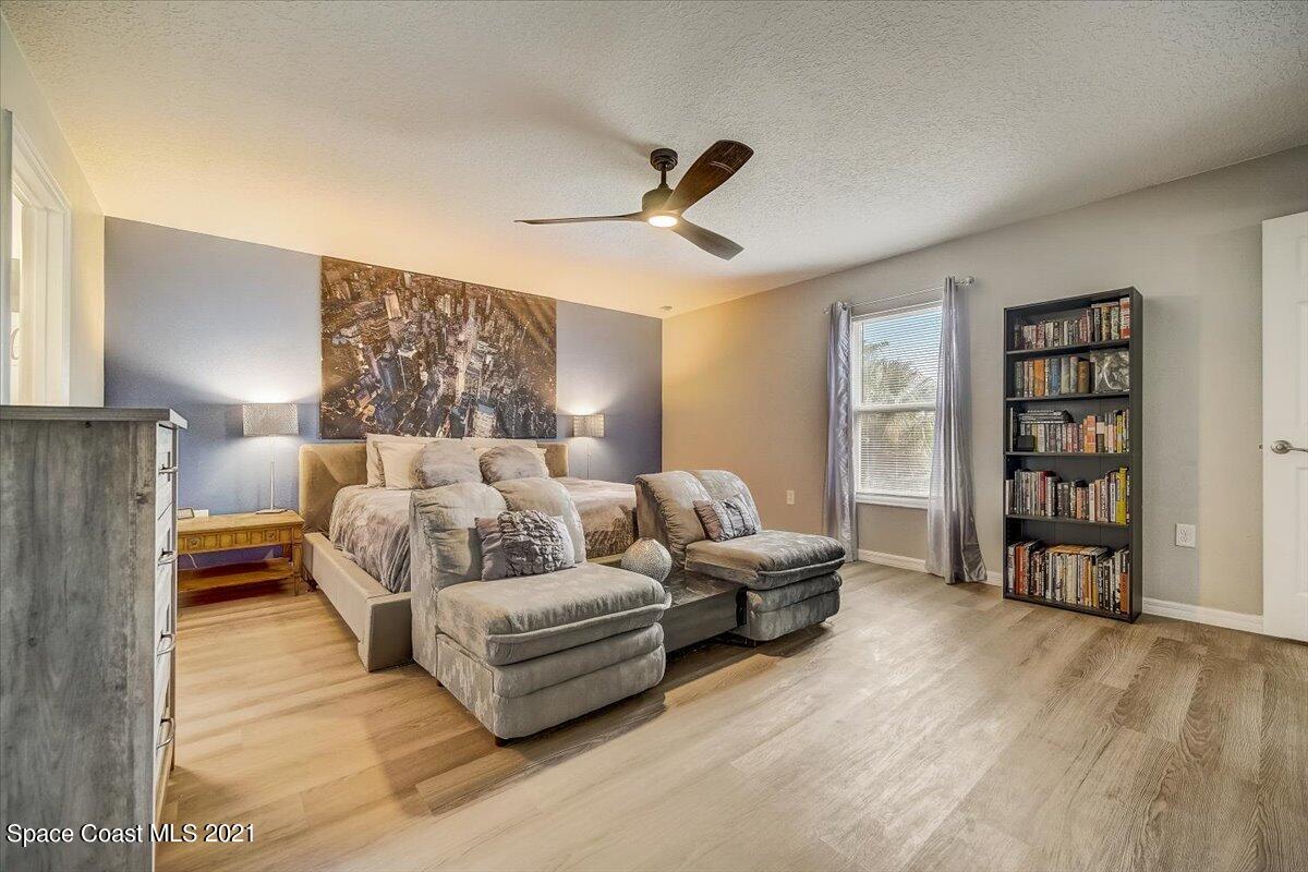 1459 Saxony Road Southwest Palm Bay, FL 32908 - Photo 24 of 38 a living room with furniture and a ceiling fan