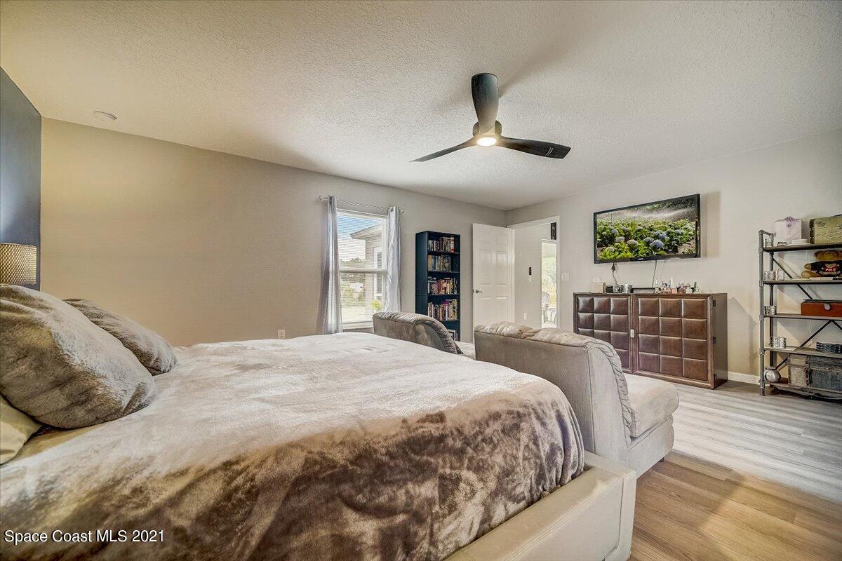 1459 Saxony Road Southwest Palm Bay, FL 32908 - Photo 25 of 38 a bedroom with a large bed closet and a large window