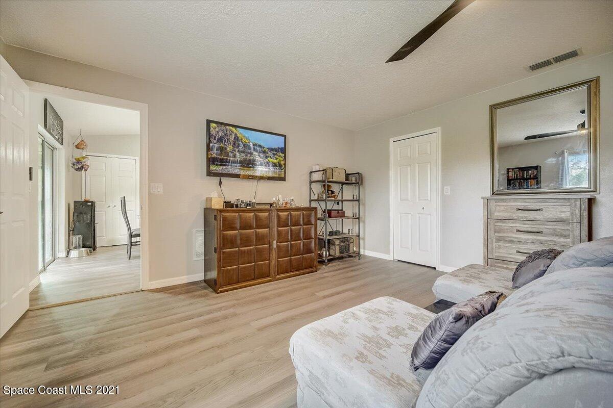 1459 Saxony Road Southwest Palm Bay, FL 32908 - Photo 27 of 38 a living room with furniture and a dresser