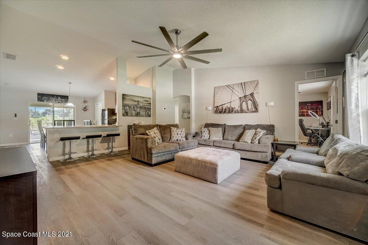 1459 Saxony Road Southwest Palm Bay, FL 32908 - Photo 4 of 38 a living room with furniture and a table