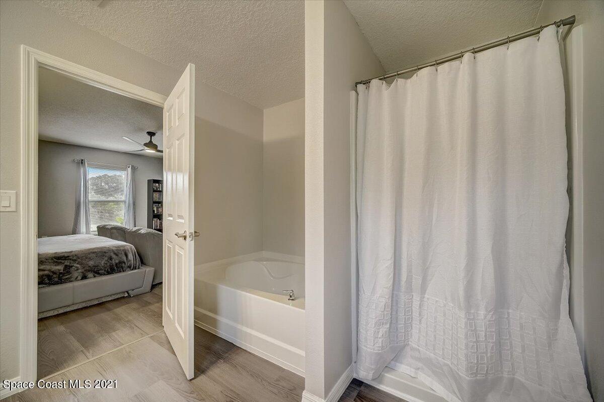 1459 Saxony Road Southwest Palm Bay, FL 32908 - Photo 31 of 38 a en suite bathroom with a sink and a mirror