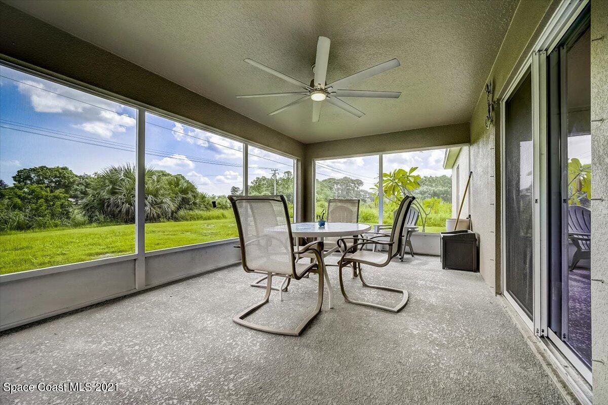 1459 Saxony Road Southwest Palm Bay, FL 32908 - Photo 32 of 38 a view of a porch with chairs and backyard