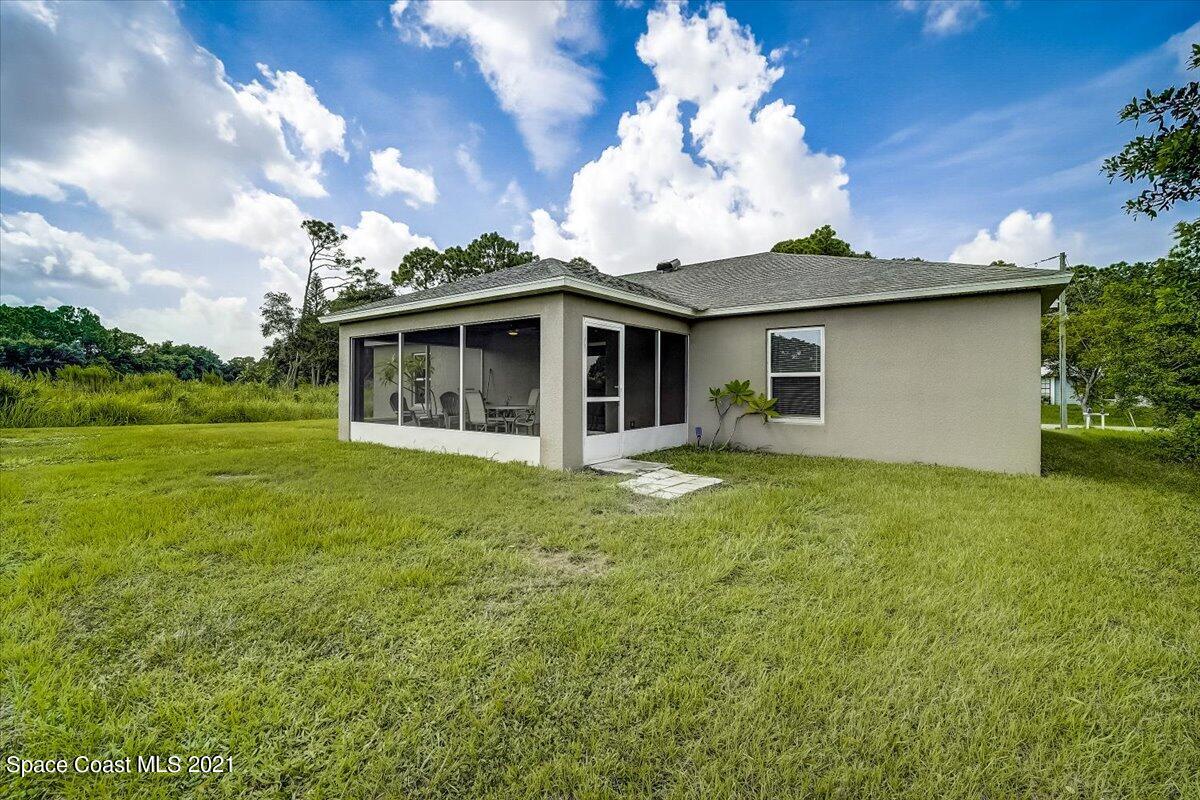 1459 Saxony Road Southwest Palm Bay, FL 32908 - Photo 34 of 38 a view of a house with pool and garden
