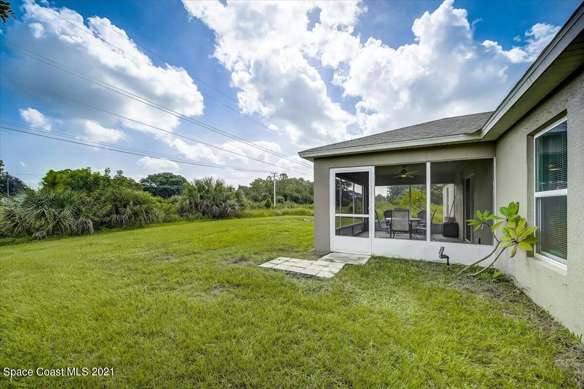 1459 Saxony Road Southwest Palm Bay, FL 32908 - Photo 35 of 38 a view of a house with backyard and porch