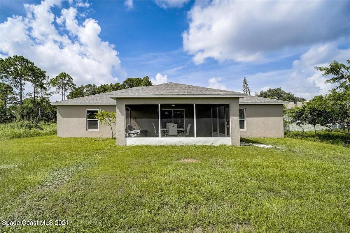 1459 Saxony Road Southwest Palm Bay, FL 32908 - Photo 36 of 38 a front view of a house with a garden