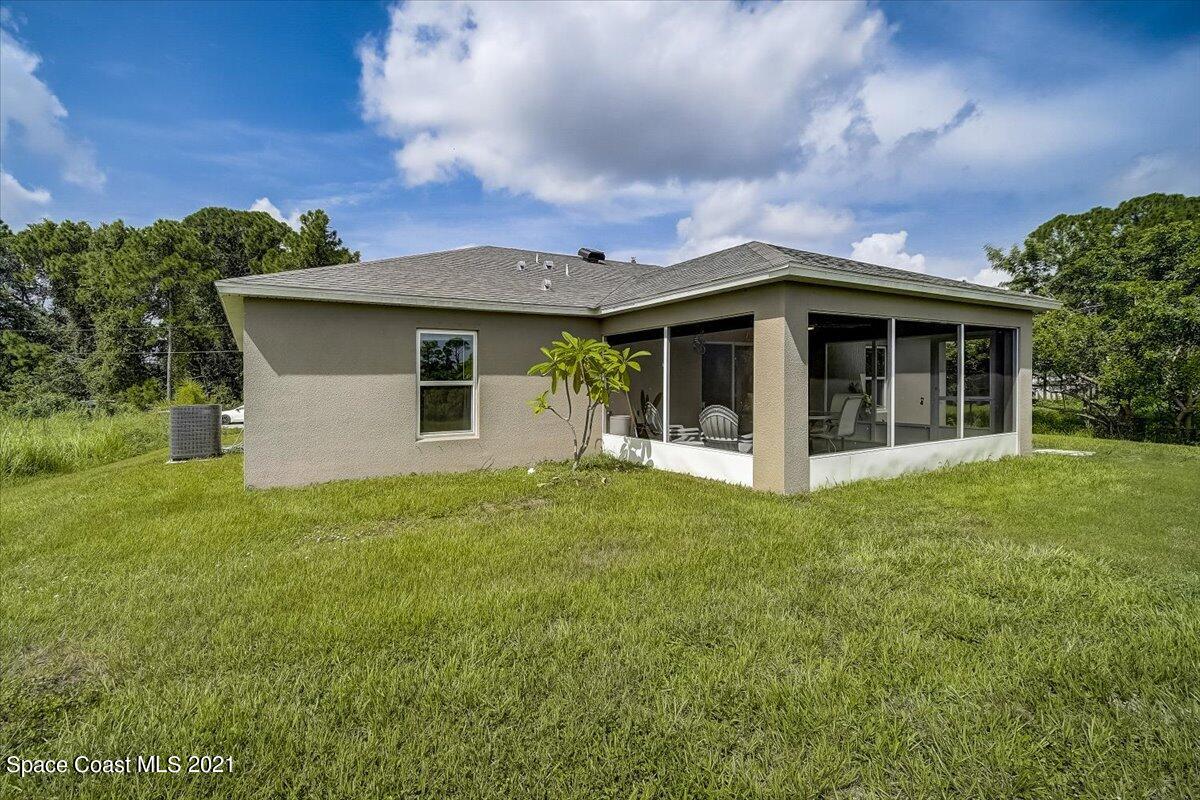 1459 Saxony Road Southwest Palm Bay, FL 32908 - Photo 37 of 38 a view of a house with backyard porch and garden