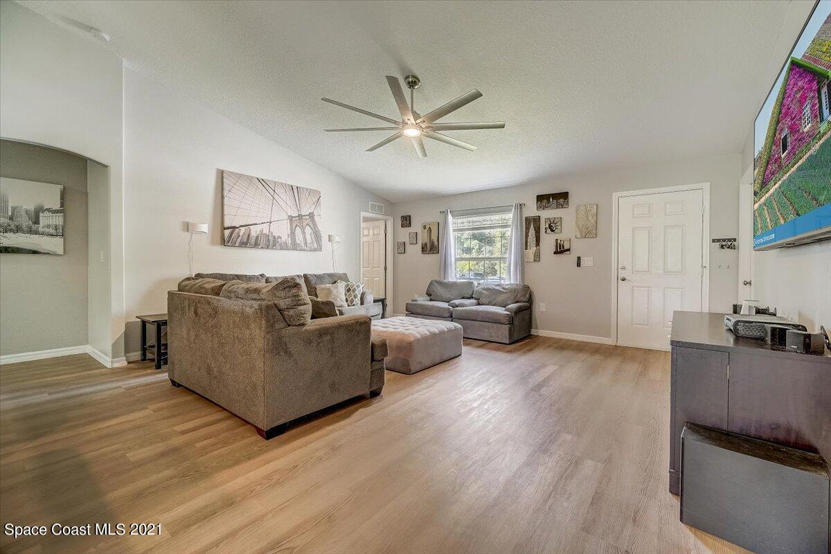 1459 Saxony Road Southwest Palm Bay, FL 32908 - Photo 5 of 38 a living room with furniture and a wooden floor