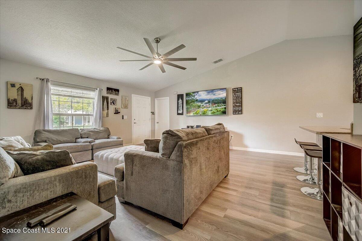 1459 Saxony Road Southwest Palm Bay, FL 32908 - Photo 7 of 38 a living room with furniture and a window