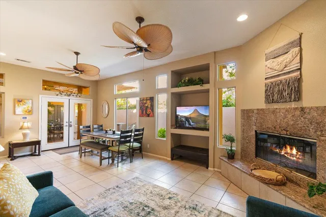 a living room with fireplace furniture and a large window