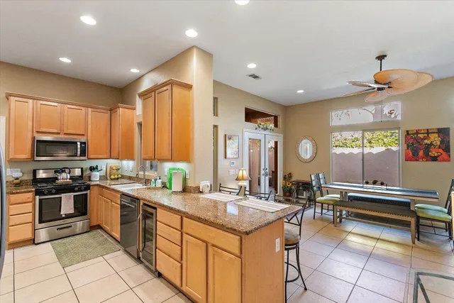 a kitchen with stainless steel appliances granite countertop a sink and cabinets