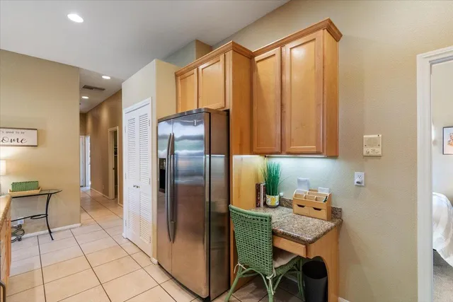 a kitchen with stainless steel appliances granite countertop a refrigerator and a sink