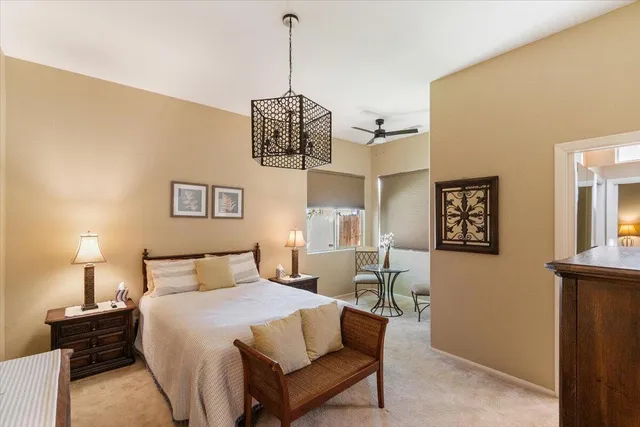 a bedroom with a bed and lamp on table