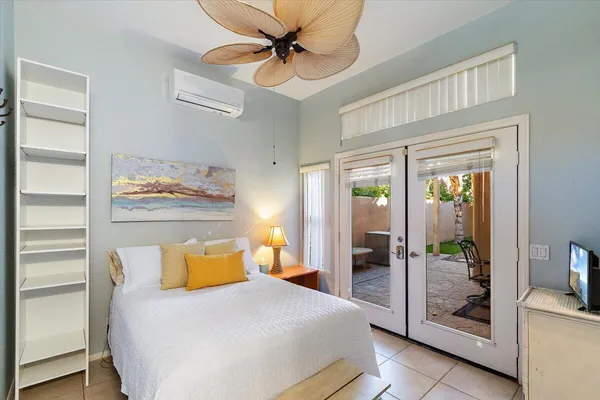 a bedroom with a bed and a glass walk in closet