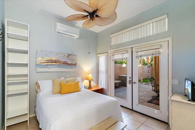 a bedroom with a bed and a glass walk in closet