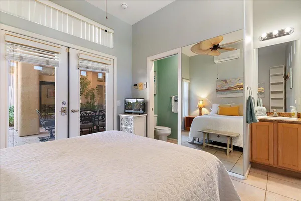 a bedroom with a bed and a mirror