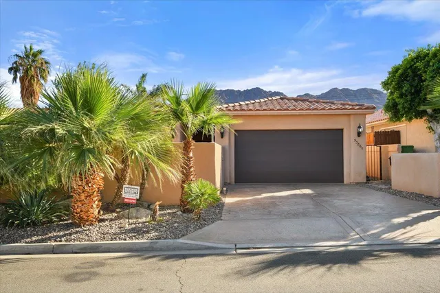 a front view of a house with yard and a garage