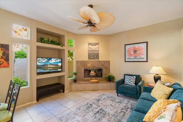 a living room with furniture a fireplace and a flat screen tv