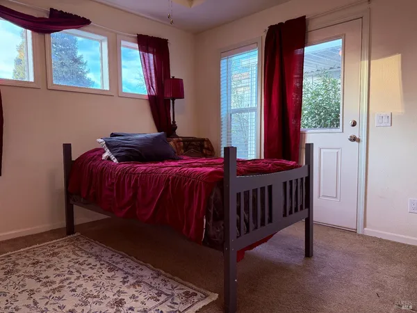 a bedroom with a bed and window