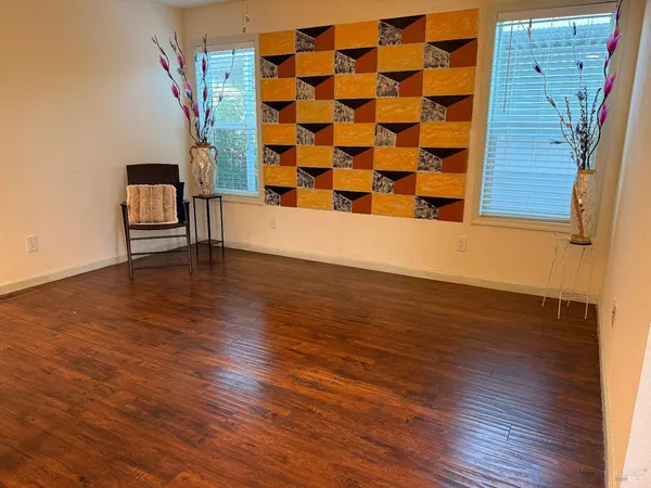 wooden floor in a hall with a window