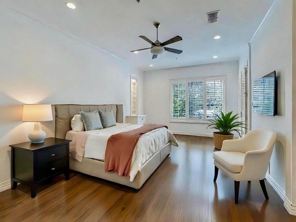 2811 Hood Street, Unit B Dallas, TX 75219 - Photo 15 of 30 a bedroom with a bed and wooden floor