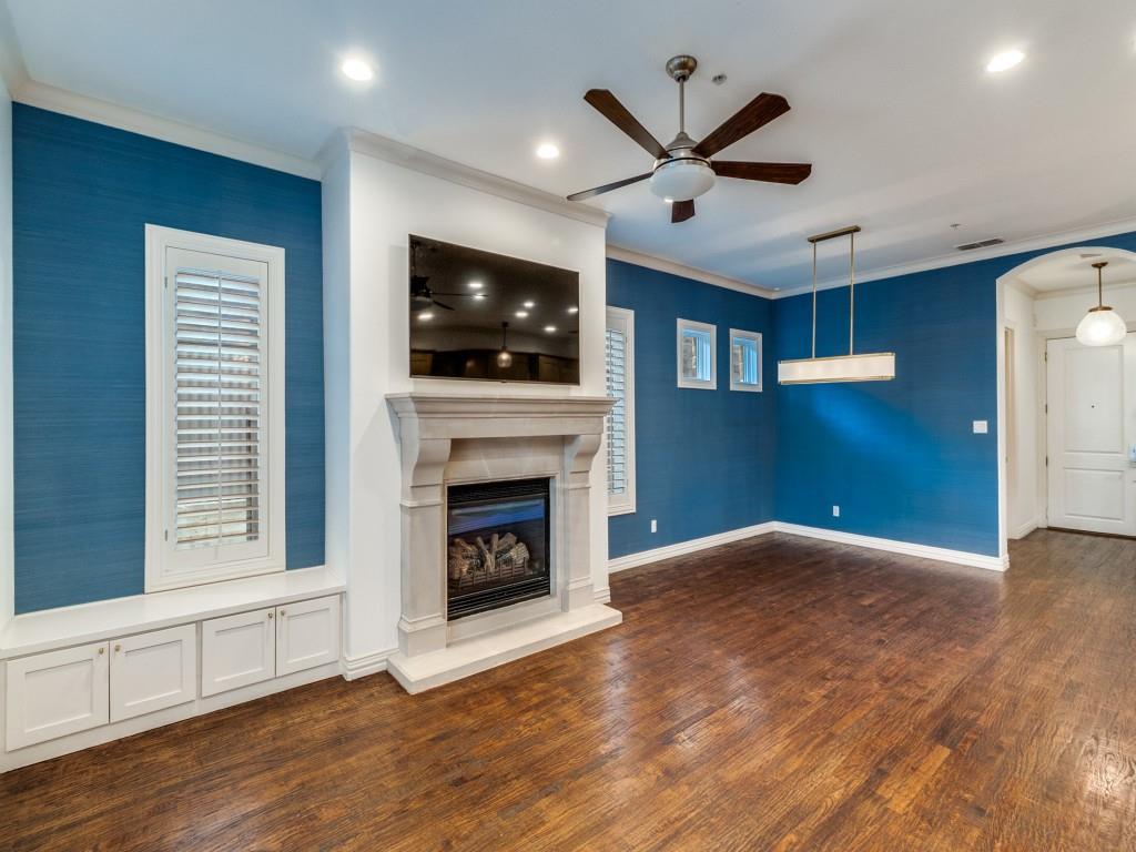 2811 Hood Street, Unit B Dallas, TX 75219 - Photo 2 of 30 a living room with a flat screen tv and a fireplace