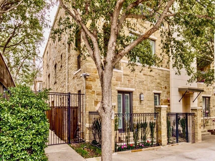 2811 Hood Street, Unit B Dallas, TX 75219 - Photo 27 of 30 a view of a brick house with large windows and a large tree