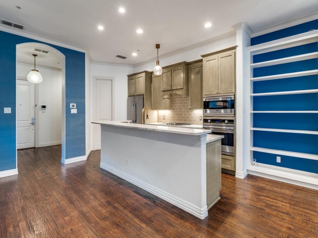2811 Hood Street, Unit B Dallas, TX 75219 - Photo 4 of 30 a kitchen with stainless steel appliances a refrigerator and wooden floor