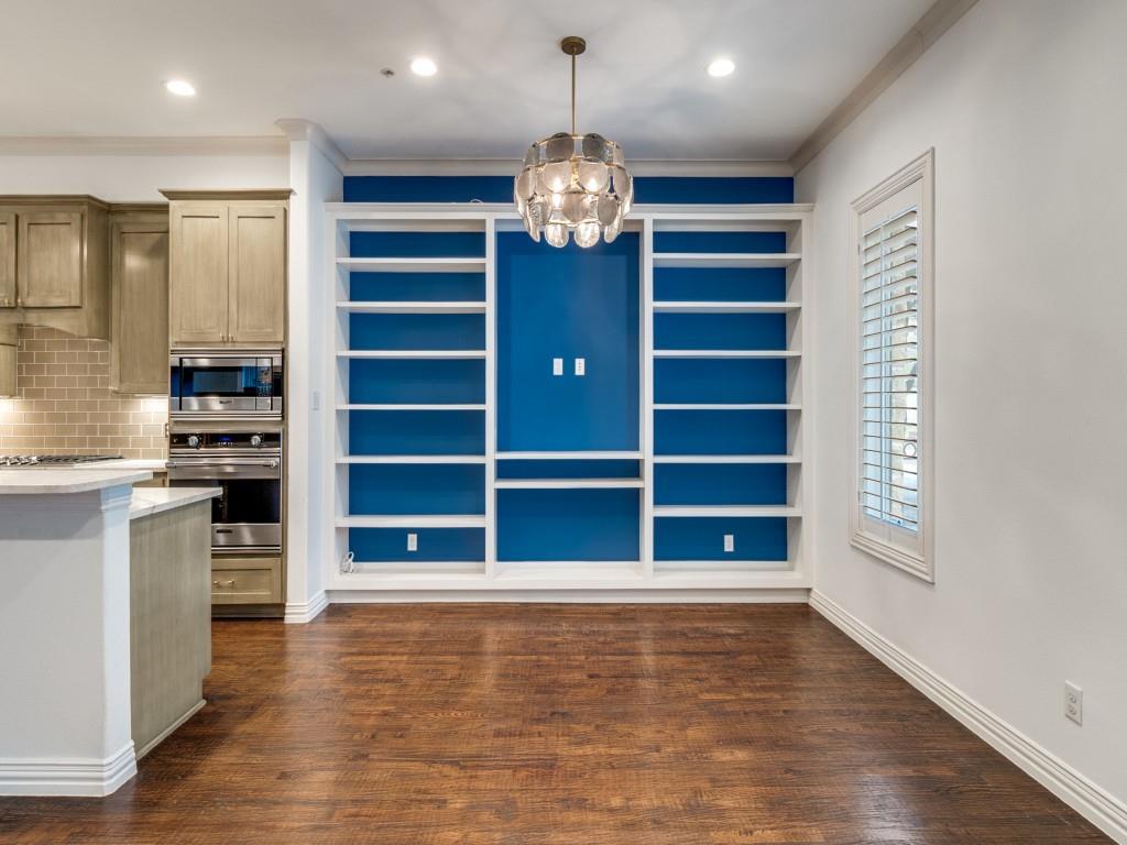 2811 Hood Street, Unit B Dallas, TX 75219 - Photo 6 of 30 a view of an empty room with a fireplace and a window