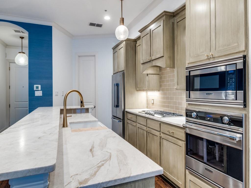 2811 Hood Street, Unit B Dallas, TX 75219 - Photo 9 of 30 a kitchen with stainless steel appliances granite countertop a stove and a microwave