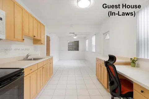 a kitchen with a sink a stove and cabinets