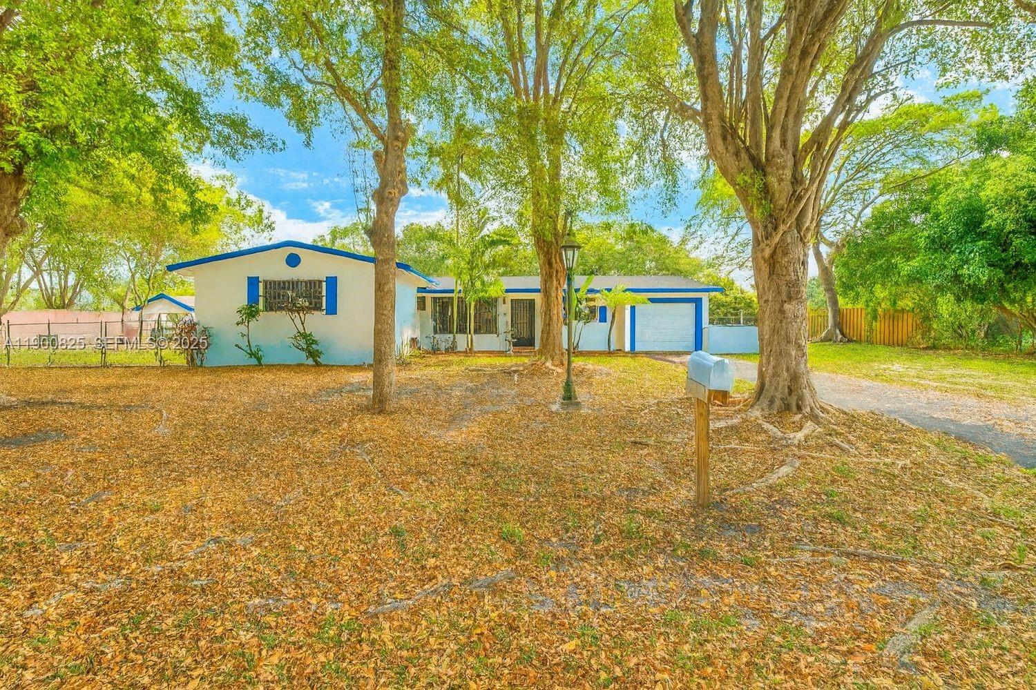 7800 Southwest 95th Street Miami, FL 33156 - Photo 8 of 17 a front view of a house with a yard
