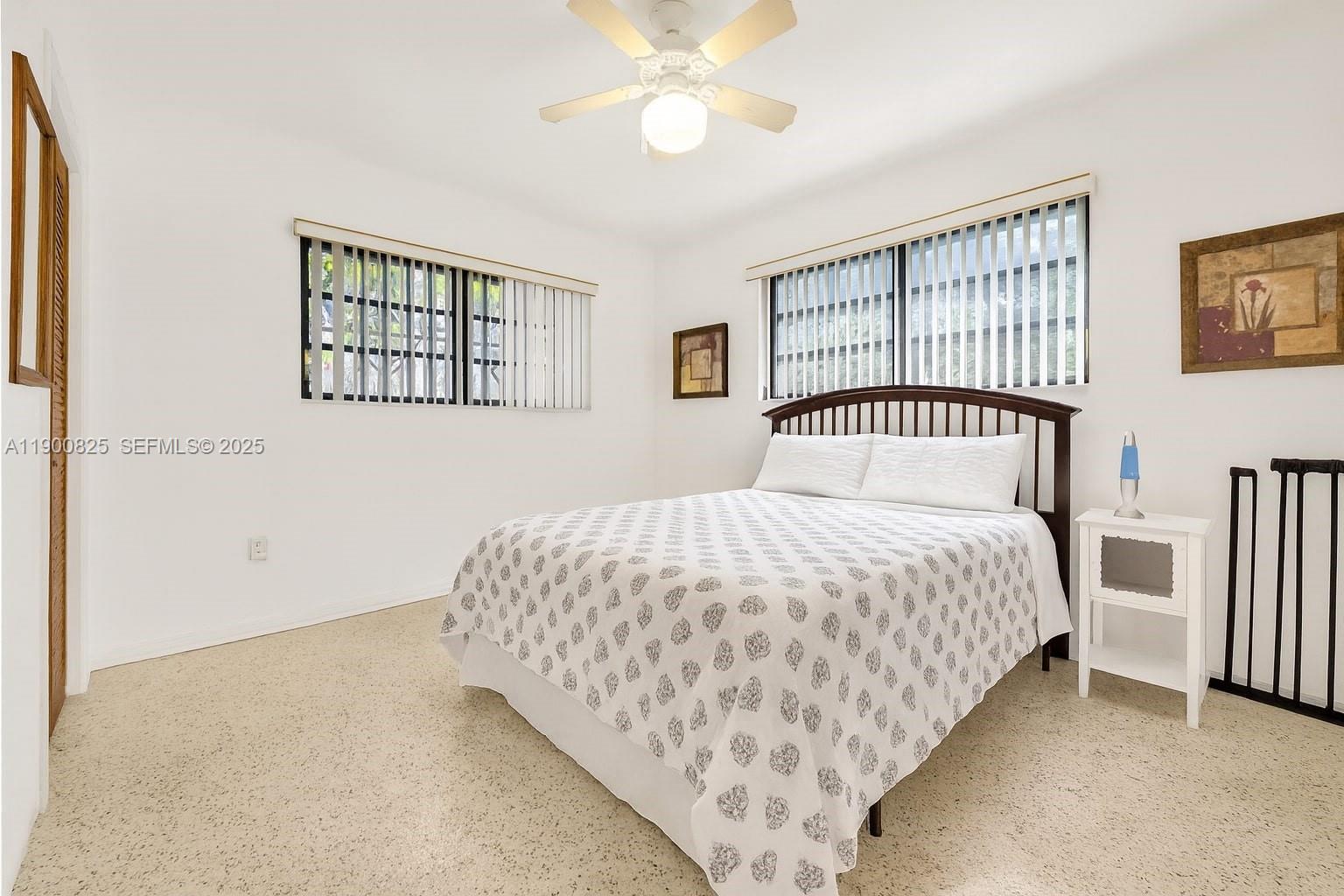 7800 Southwest 95th Street Miami, FL 33156 - Photo 9 of 17 a bedroom with a bed and a chandelier