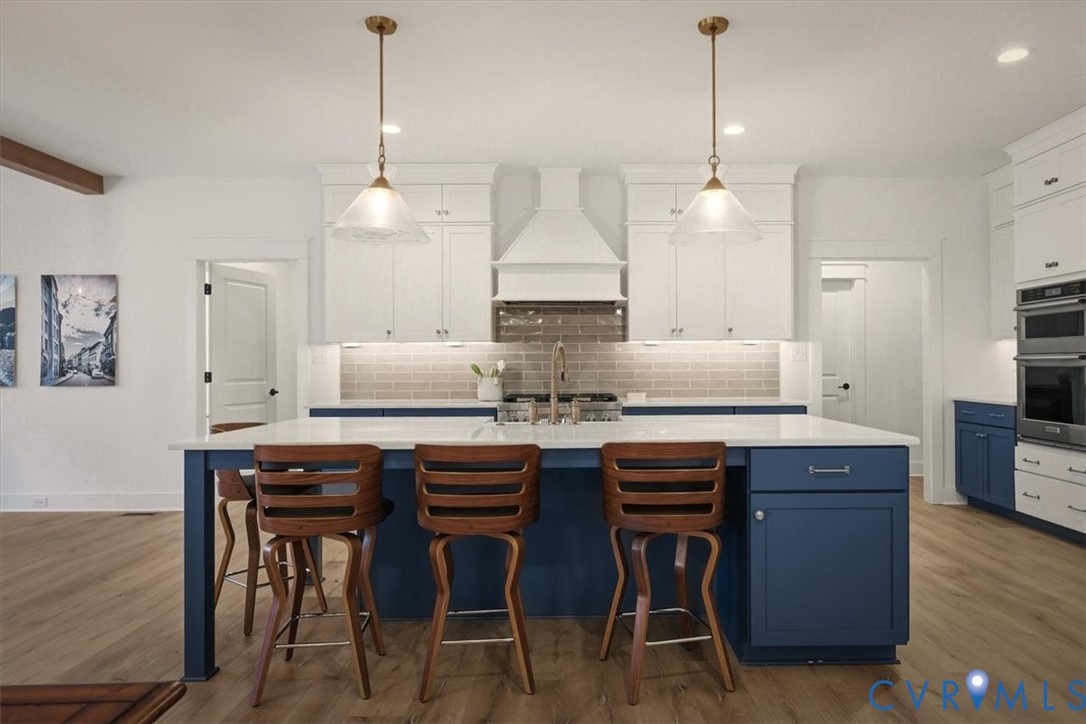 702 Hockett Road Manakin-Sabot, VA 23103 - Photo 22 of 45 a kitchen with stainless steel appliances granite countertop a table chairs stove and white cabinets