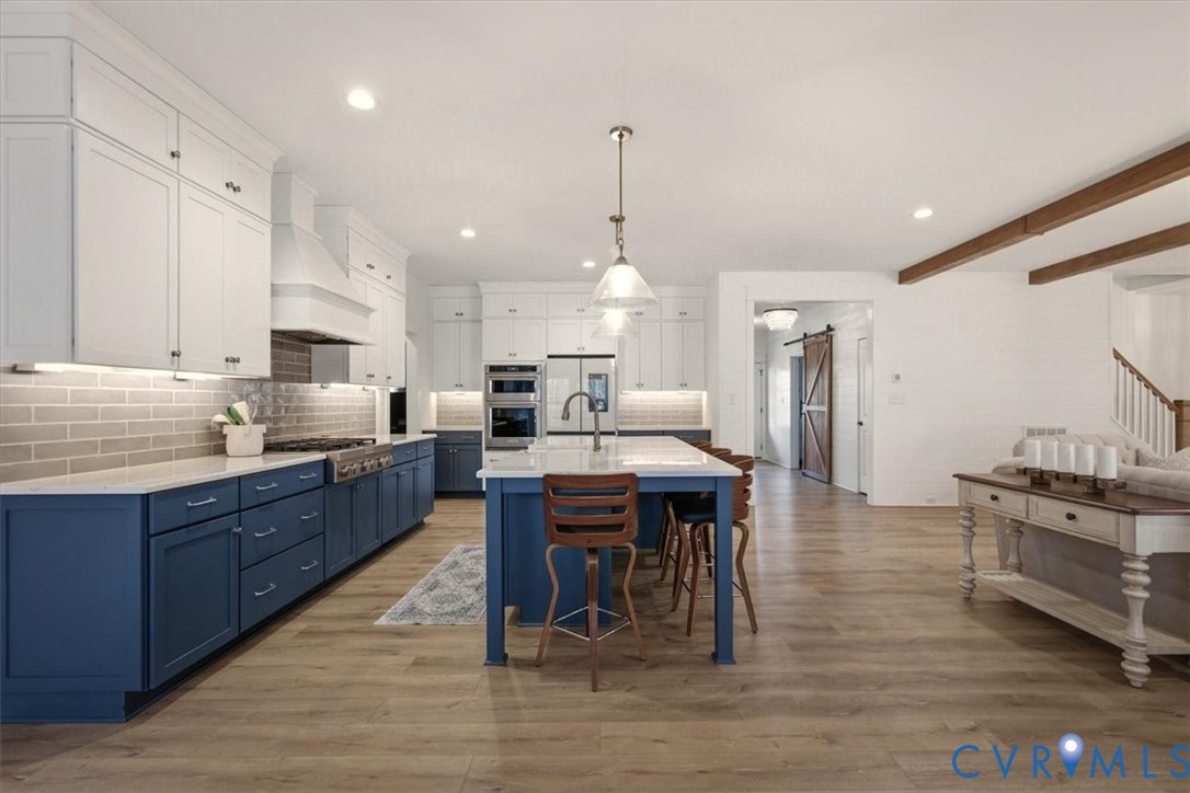 702 Hockett Road Manakin-Sabot, VA 23103 - Photo 23 of 45 a large kitchen with stainless steel appliances lots of counter space dining table and chairs
