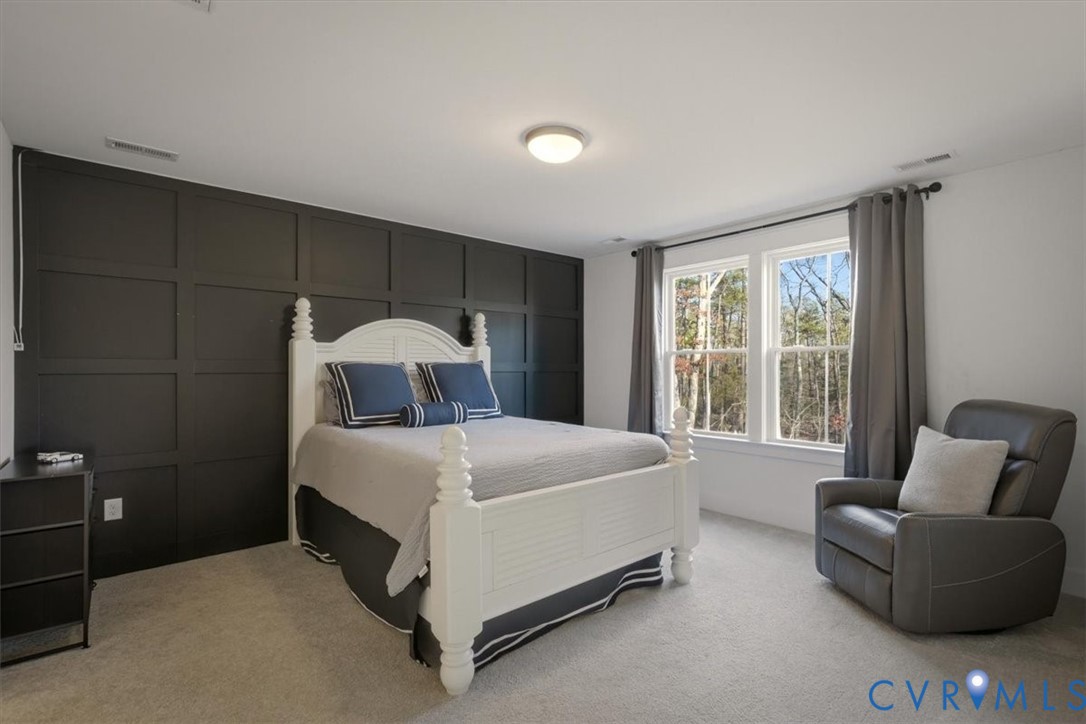 702 Hockett Road Manakin-Sabot, VA 23103 - Photo 28 of 45 a bed sitting in a bedroom next to a window