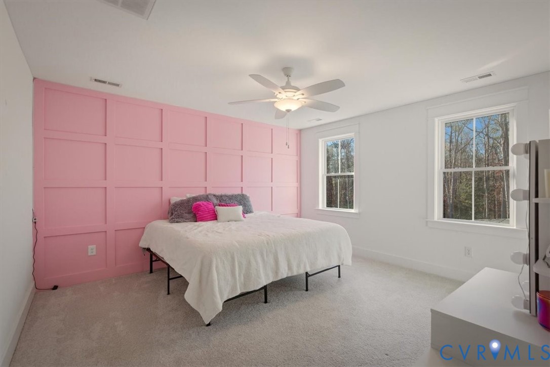 702 Hockett Road Manakin-Sabot, VA 23103 - Photo 32 of 45 a bedroom with a bed and a chandelier