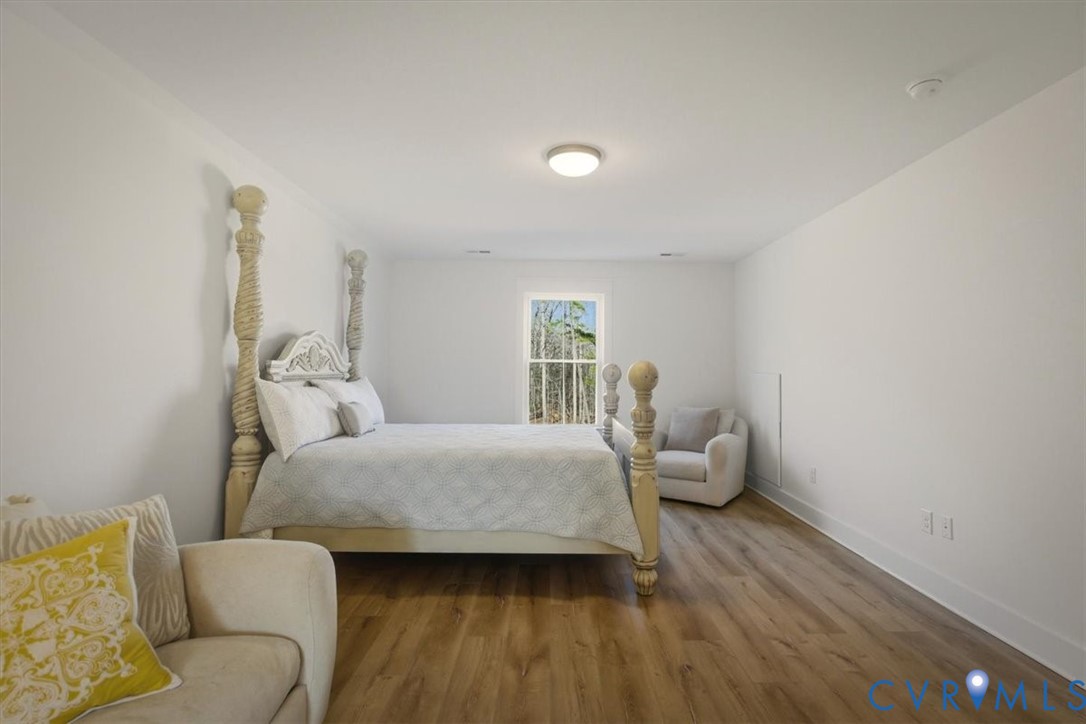 702 Hockett Road Manakin-Sabot, VA 23103 - Photo 34 of 45 a bedroom with a bed and wooden floor