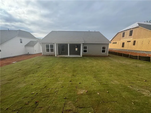 a front view of a house with a yard table and chairs