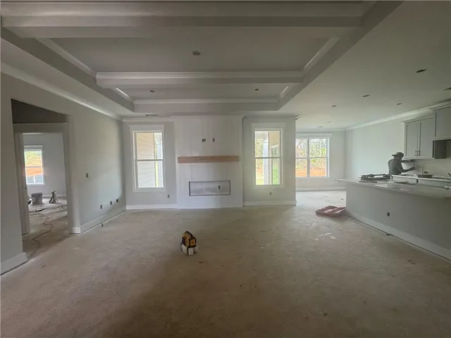 a room with a window and a view of kitchen