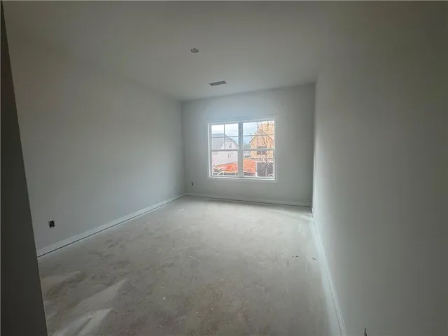 an empty room with a window and a fireplace