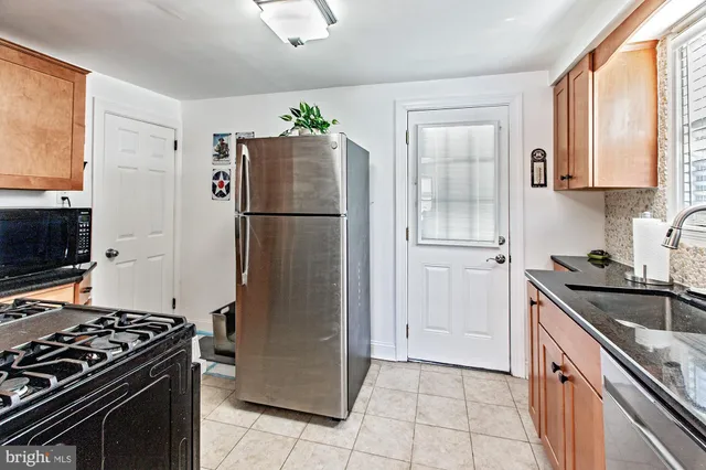 a kitchen with a stove a refrigerator and a sink