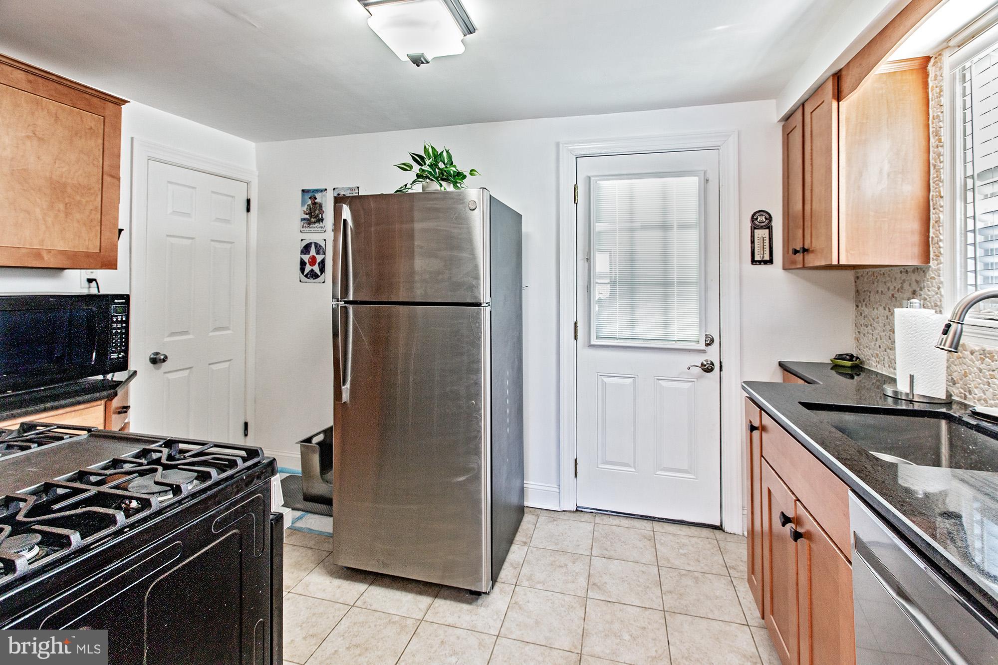 306 Village Road Wilmington, DE 19805 - Photo 6 of 21 Updated kitchen with door to the back yard