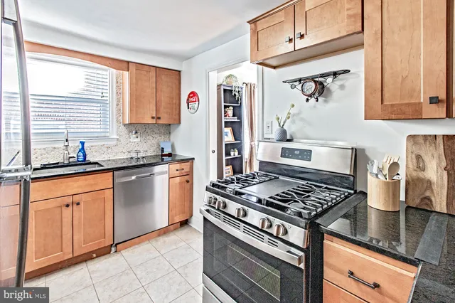 a kitchen with stainless steel appliances granite countertop a stove and a sink