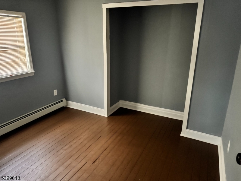 24 Outlook Avenue Budd Lake, NJ 07828 - Photo 6 of 10 an empty room with wooden floor and windows
