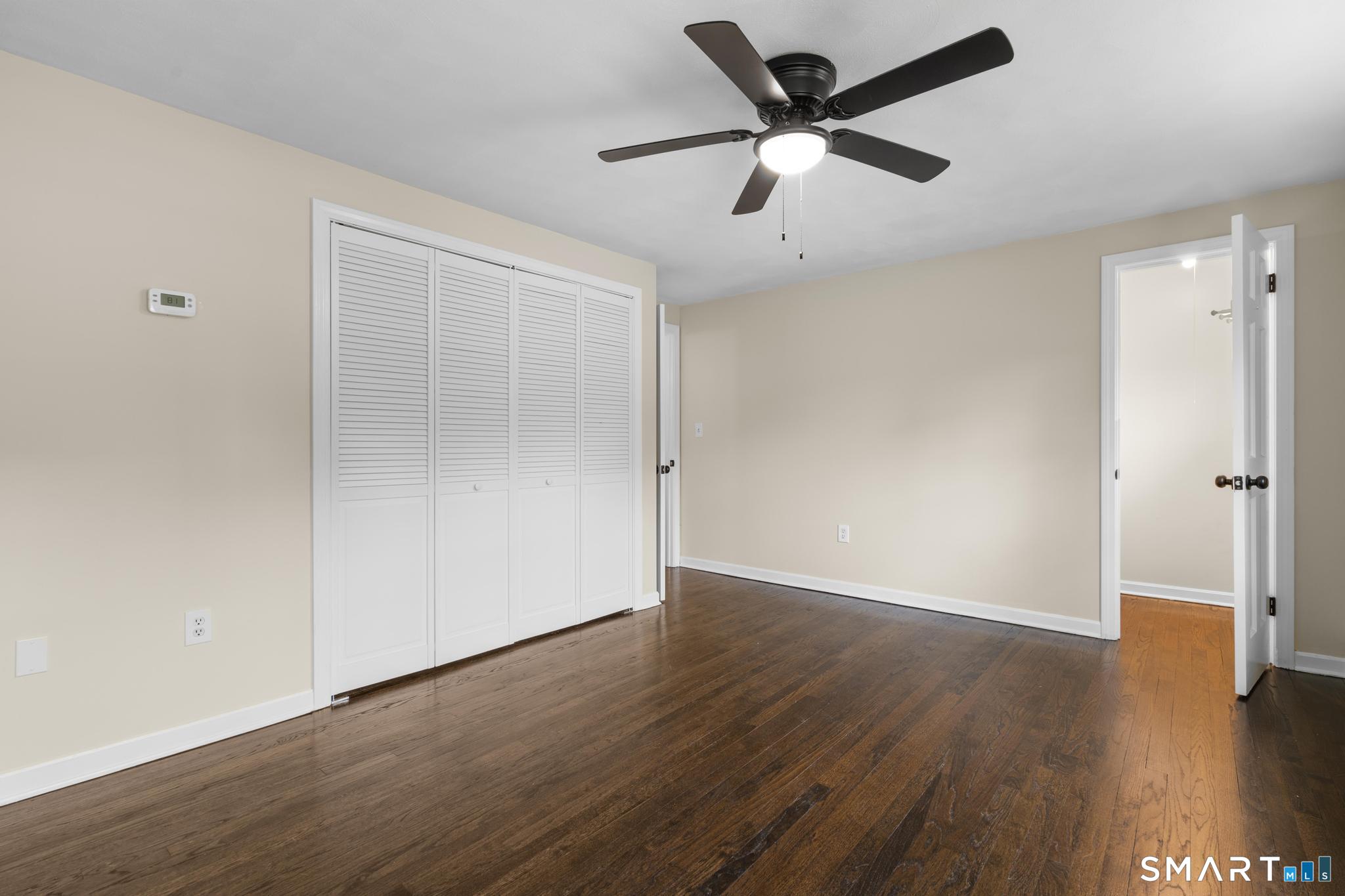 7 Sycamore Terrace Windham, CT 06280 - Photo 20 of 40 an empty room with wooden floor a ceiling fan and closet