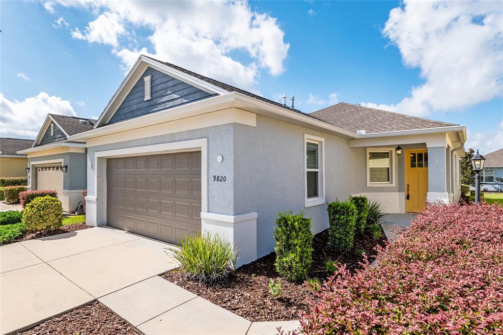 9820 Southwest 99th Loop Ocala, FL 34481 - Photo 1 of 1 a front view of a house with garden
