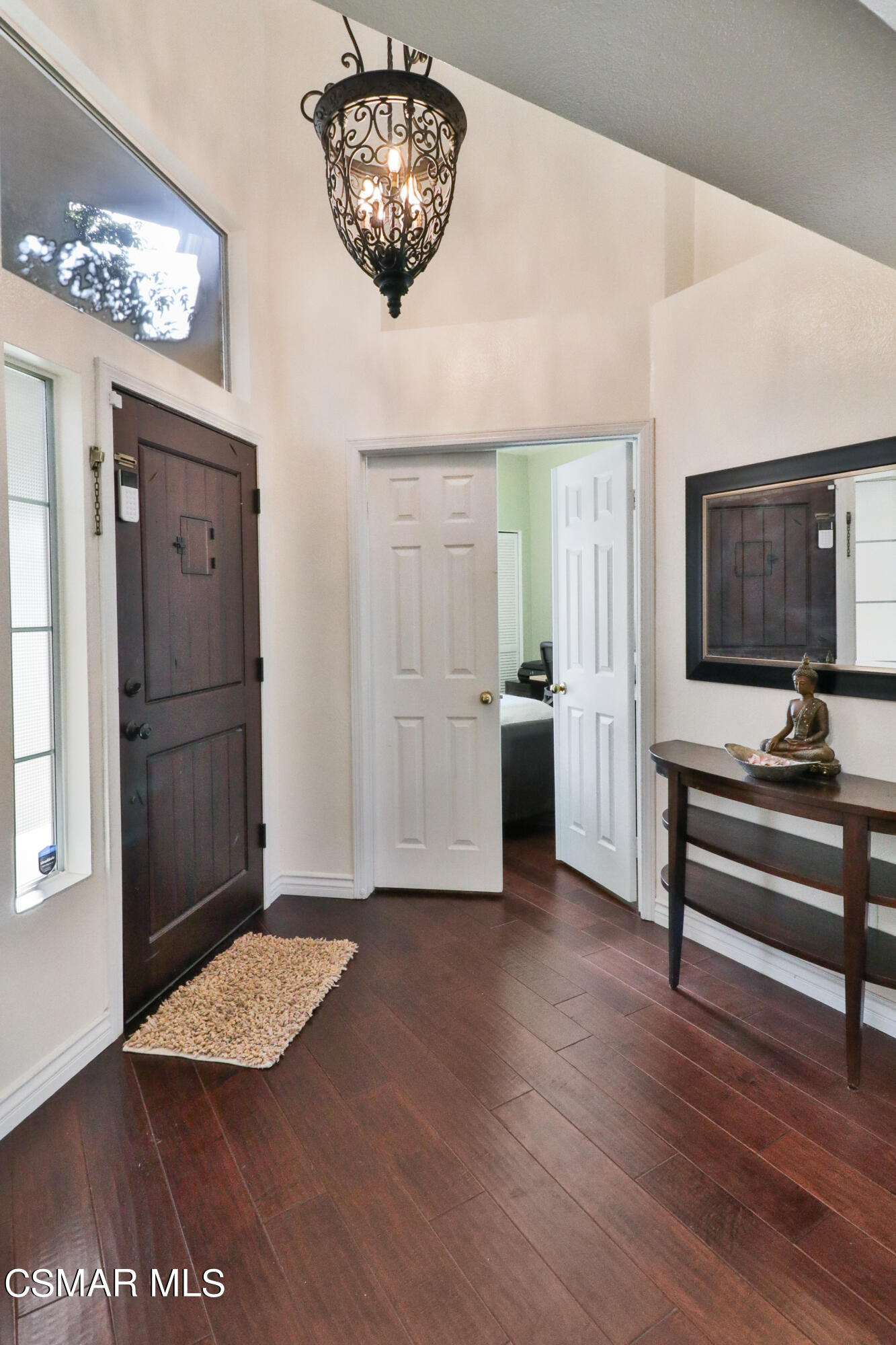 2598 Winthrop Court Simi Valley, CA 93065 - Photo 5 of 33 a view of a hallway with wooden floor and a chandelier