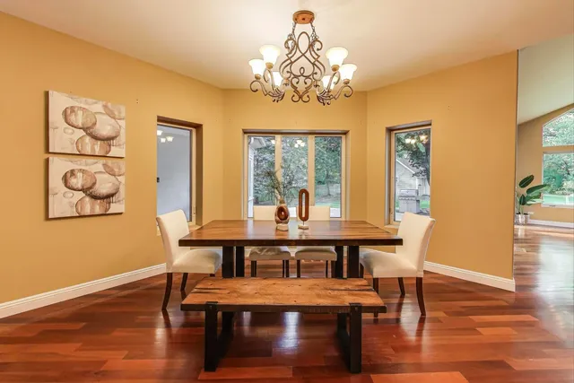 a view of a dining room with furniture wooden floor and chandelier