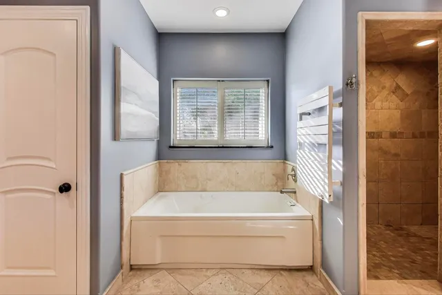 a bathroom with a bathtub and a shower