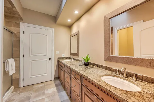 a spacious bedroom with a bed and a ceiling fan